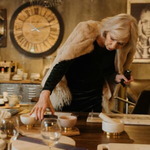 Senior woman explores merchandise in a stylish store interior, showcasing elegant decor and fashion.